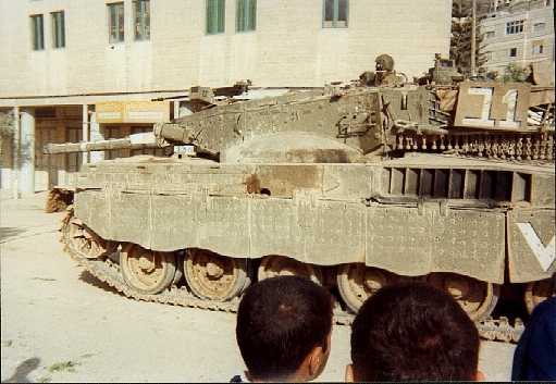 Israeli Merkava Main Battle Tank.Weighing 61 tons the main armament is a 120mm cannon capable of firing DU shells. It also carries one 7.62mm coaxial machine gun, two 7.62 Anti-personnel machine guns, a so-called commanders machine gun of 12.7mm, and a 60mm mortar. With all this fire power it is ideal for controlling and killing school children.