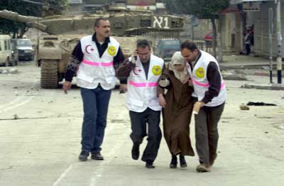 A Doctor from UPMRC and ambulance personnel evacuate civilians during the invasion.